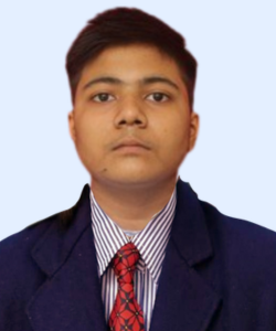 Formal portrait of a person wearing a navy blazer, striped shirt and red tie, facing the camera against a light blue background.